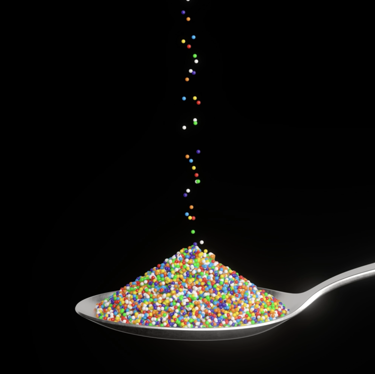 a spoon filled with colorful dots